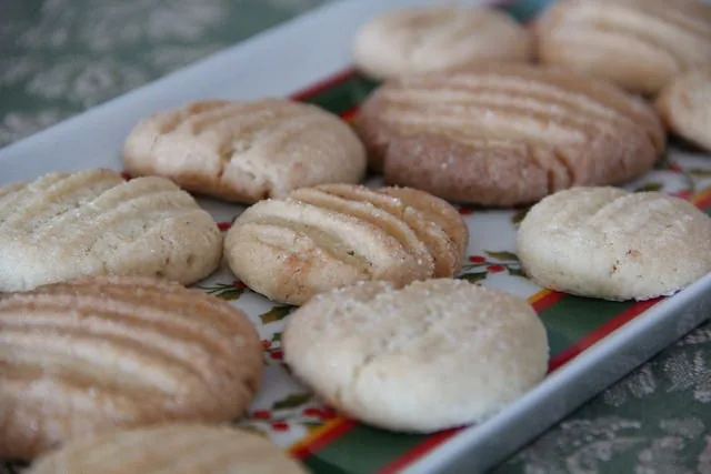 Bolachas de manteiga caseiras com marcas de garfo dispostas num tabuleiro de ir ao forno.